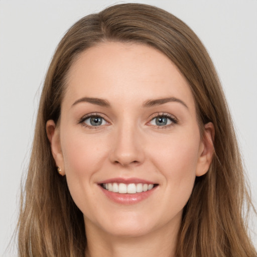 Joyful white young-adult female with long  brown hair and grey eyes