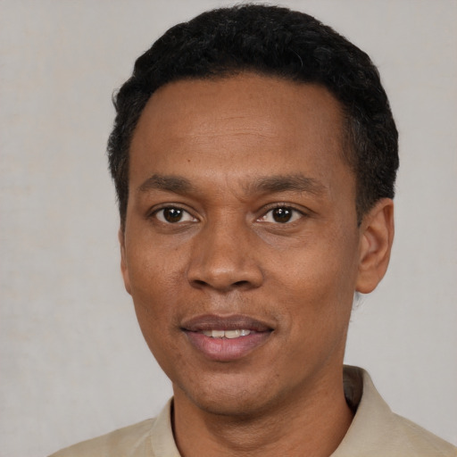 Joyful latino adult male with short  black hair and brown eyes