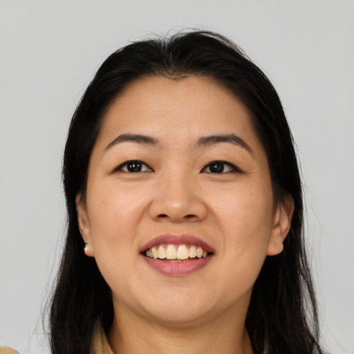 Joyful asian young-adult female with long  brown hair and brown eyes