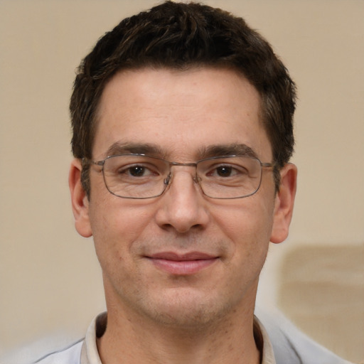 Joyful white adult male with short  brown hair and brown eyes