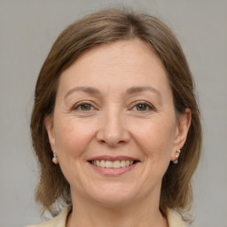 Joyful white adult female with medium  brown hair and grey eyes