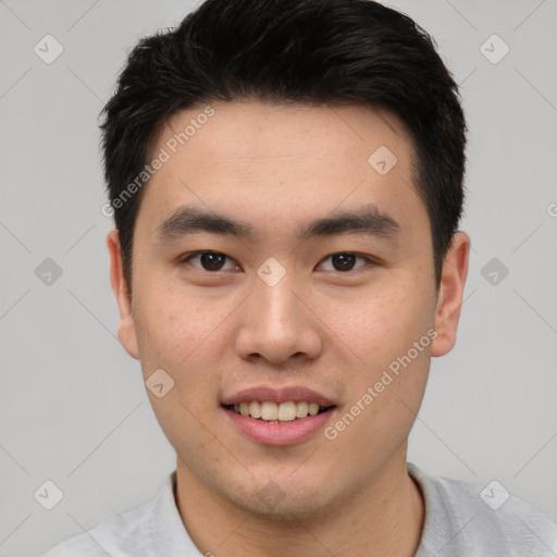 Joyful asian young-adult male with short  brown hair and brown eyes