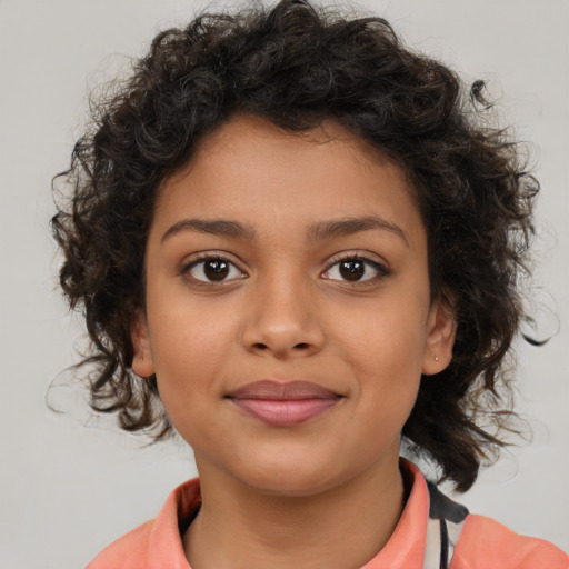 Joyful latino child female with medium  brown hair and brown eyes