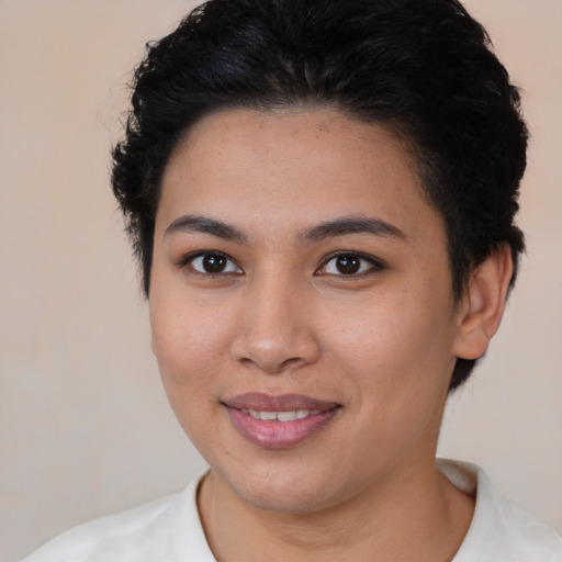 Joyful latino young-adult female with short  brown hair and brown eyes