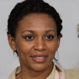 Joyful black adult female with short  brown hair and brown eyes