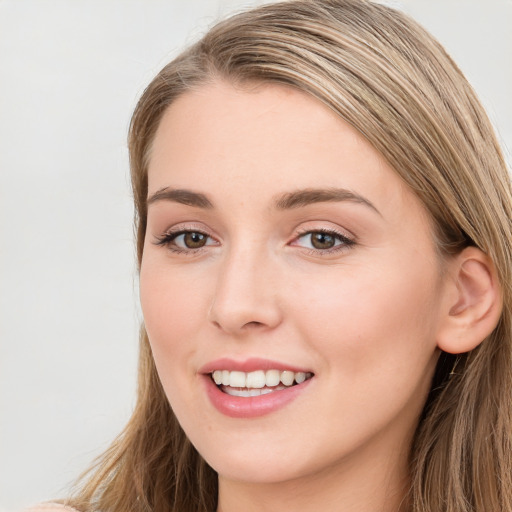 Joyful white young-adult female with long  brown hair and blue eyes