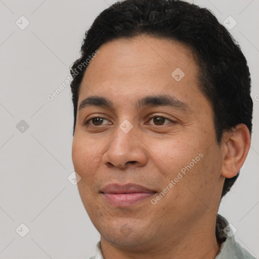 Joyful latino young-adult male with short  black hair and brown eyes