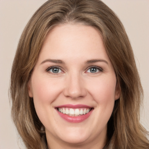 Joyful white young-adult female with medium  brown hair and green eyes