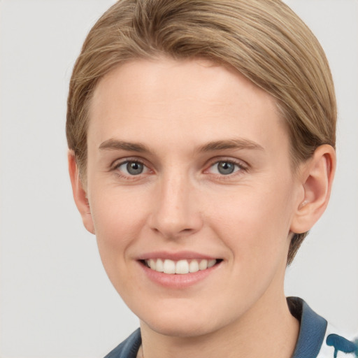 Joyful white young-adult female with short  brown hair and grey eyes