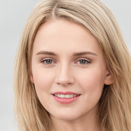 Joyful white young-adult female with long  brown hair and blue eyes