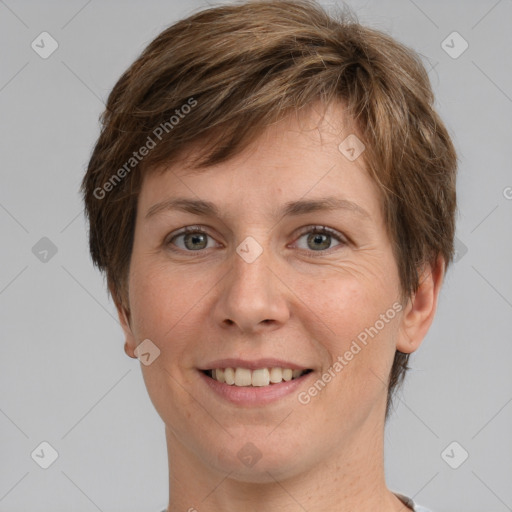 Joyful white adult female with short  brown hair and grey eyes