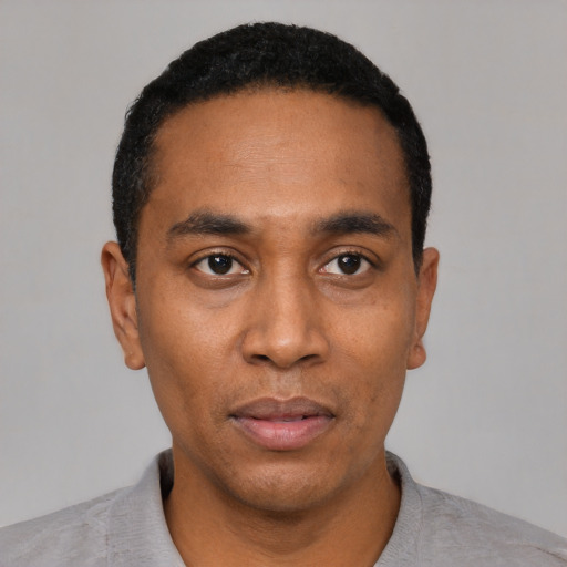 Neutral black young-adult male with short  black hair and brown eyes