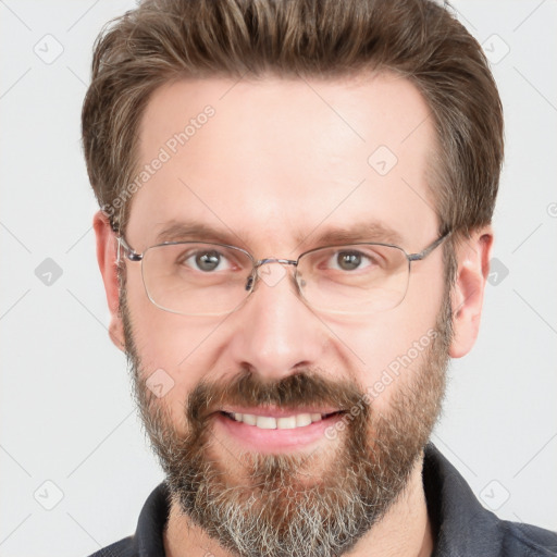 Joyful white adult male with short  brown hair and grey eyes