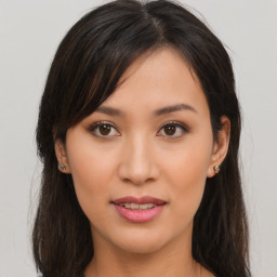 Joyful asian young-adult female with long  brown hair and brown eyes