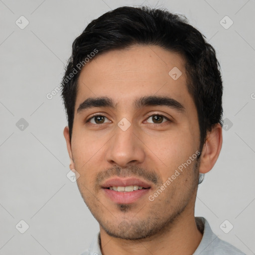 Joyful latino young-adult male with short  black hair and brown eyes