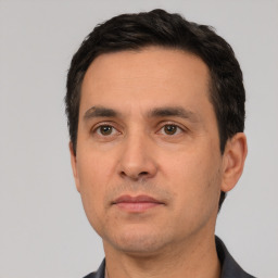 Neutral white adult male with short  black hair and brown eyes