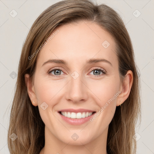 Joyful white young-adult female with long  brown hair and grey eyes