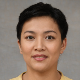 Joyful asian young-adult female with short  brown hair and brown eyes