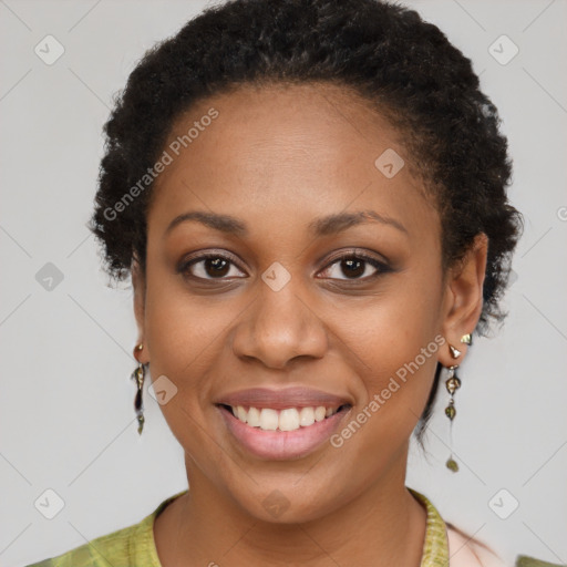 Joyful black young-adult female with short  brown hair and brown eyes