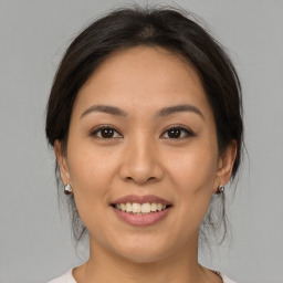 Joyful asian young-adult female with medium  brown hair and brown eyes