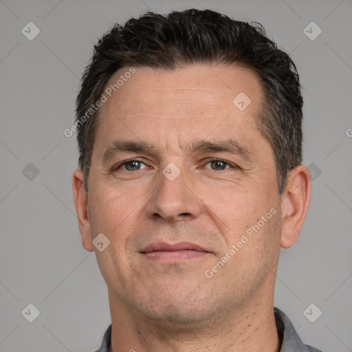 Joyful white adult male with short  brown hair and brown eyes