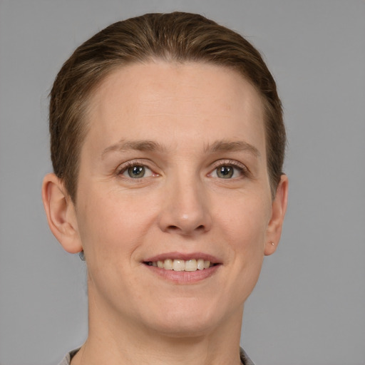 Joyful white adult female with short  brown hair and grey eyes