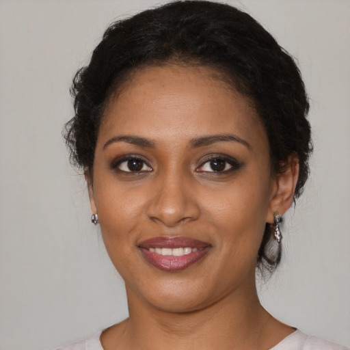 Joyful black young-adult female with medium  black hair and brown eyes