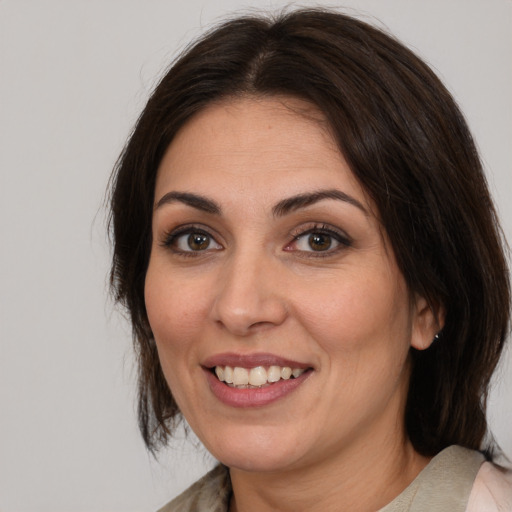 Joyful white adult female with medium  brown hair and brown eyes