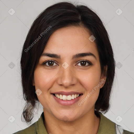 Joyful latino young-adult female with medium  brown hair and brown eyes