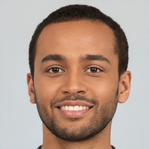 Joyful latino young-adult male with short  brown hair and brown eyes