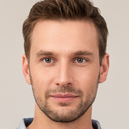 Joyful white young-adult male with short  brown hair and brown eyes