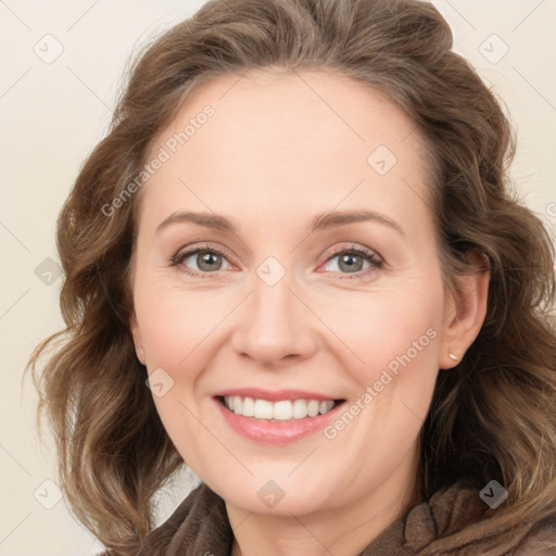 Joyful white adult female with medium  brown hair and blue eyes