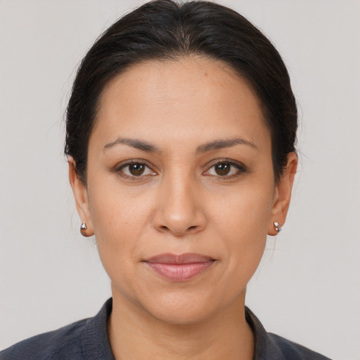 Joyful latino young-adult female with medium  brown hair and brown eyes