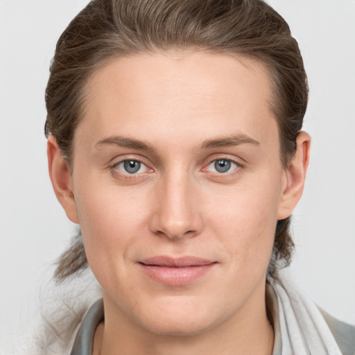 Joyful white young-adult female with long  brown hair and grey eyes