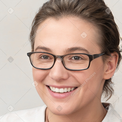 Joyful white young-adult female with medium  brown hair and brown eyes