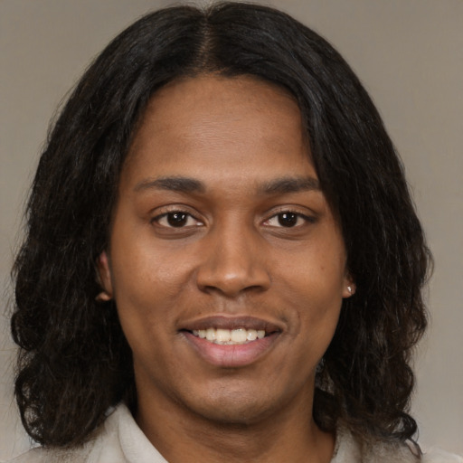Joyful black young-adult female with medium  black hair and brown eyes