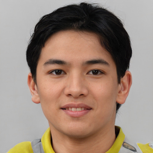 Joyful asian young-adult male with short  brown hair and brown eyes