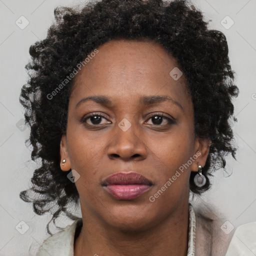 Joyful black adult female with short  brown hair and brown eyes