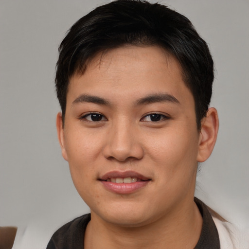 Joyful asian young-adult male with short  brown hair and brown eyes