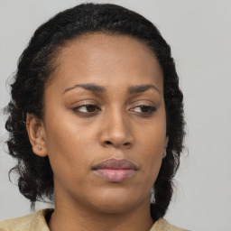 Neutral black young-adult female with long  brown hair and brown eyes