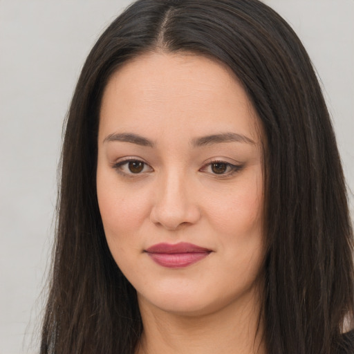 Joyful asian young-adult female with long  brown hair and brown eyes