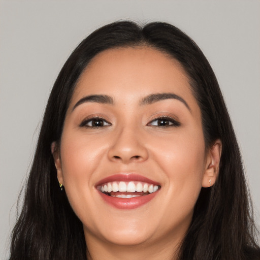 Joyful white young-adult female with long  black hair and brown eyes