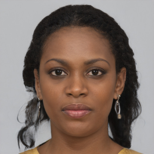 Neutral black young-adult female with medium  brown hair and brown eyes