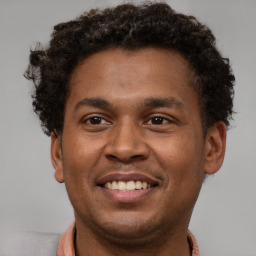 Joyful latino young-adult male with short  brown hair and brown eyes