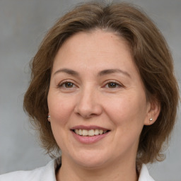 Joyful white adult female with medium  brown hair and brown eyes