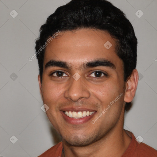 Joyful white young-adult male with short  black hair and brown eyes