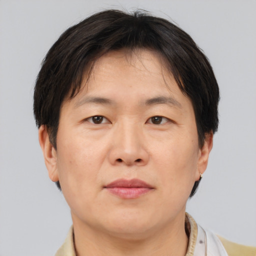 Neutral asian adult male with short  brown hair and brown eyes