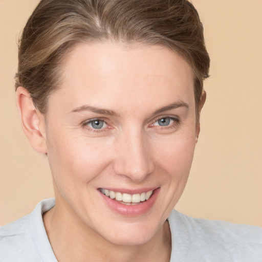 Joyful white young-adult female with short  brown hair and grey eyes