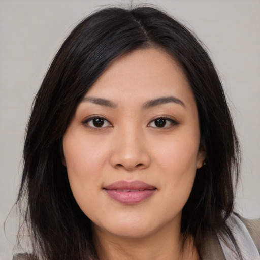 Joyful asian young-adult female with medium  black hair and brown eyes
