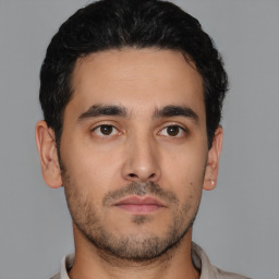Neutral latino young-adult male with short  brown hair and brown eyes